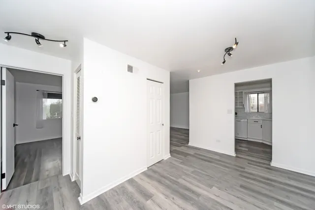 a view of hallway with wooden floor