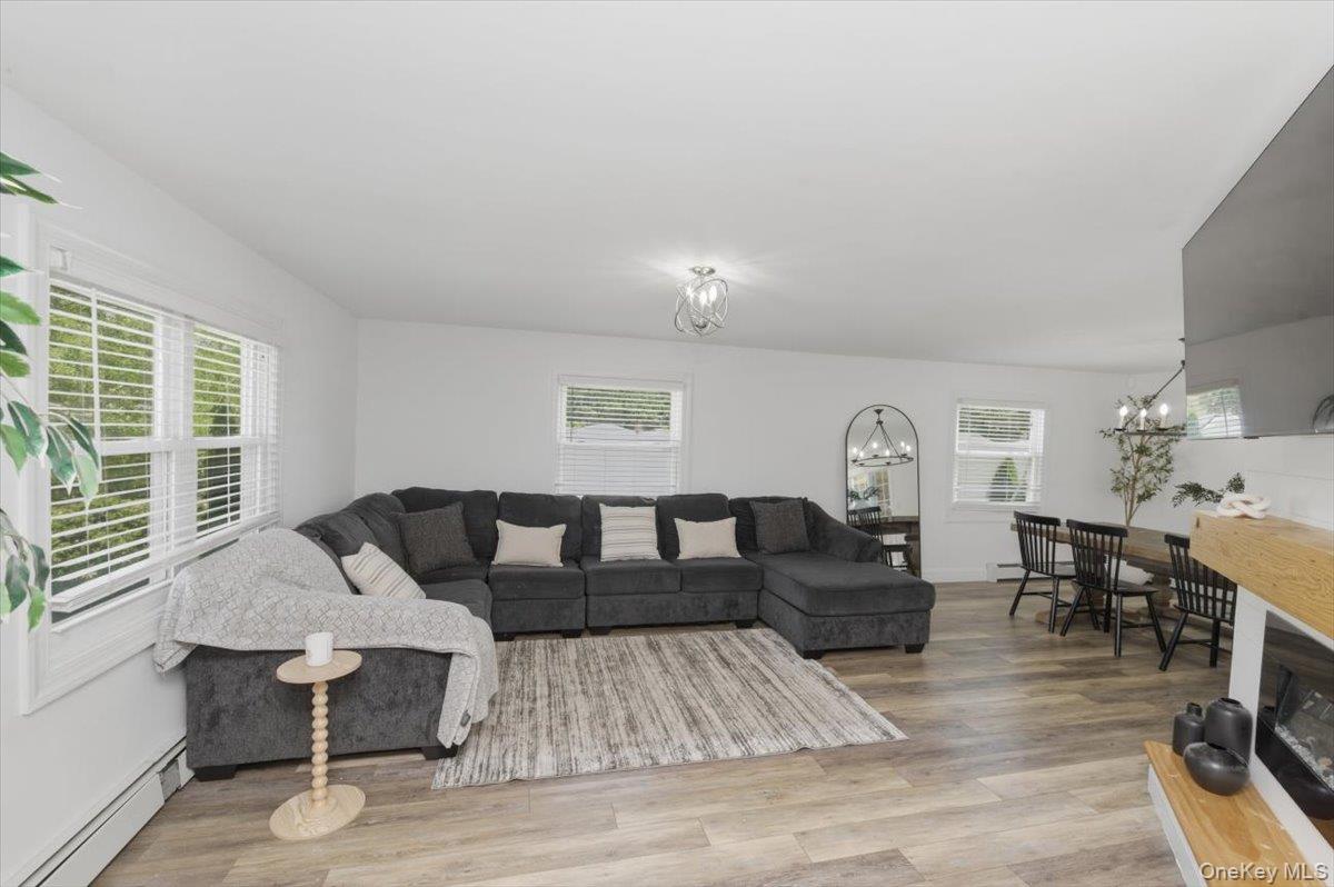 10 Rutgers Road Farmingville, NY 11738 - Photo 3 of 27 a living room with furniture and wooden floor