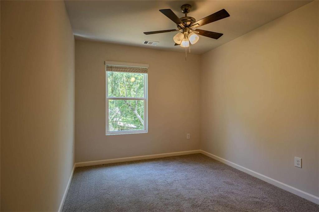 23 Sweetspire Drive Rome, GA 30165 - Photo 8 of 22 an empty room with a window and a fan