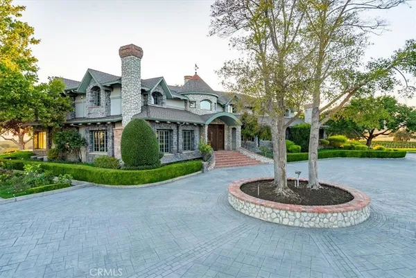 a view of a house with yard and sitting area
