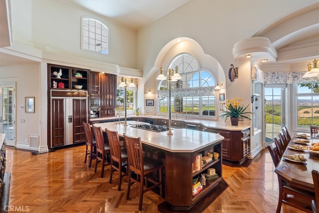 8283 Cross Canyons Road San Miguel, CA 93451 - Photo 22 of 73 a dining hall with stainless steel appliances granite countertop a dining table and chairs with wooden floor