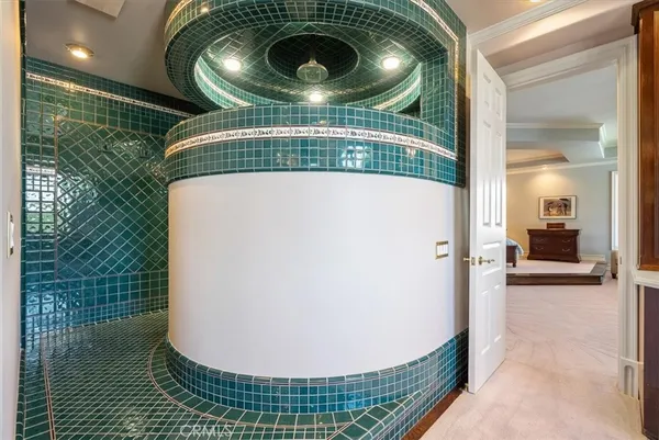 a bathroom with a sink a toilet and a large mirror