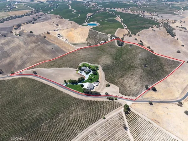 an aerial view of a house with a yard and garage