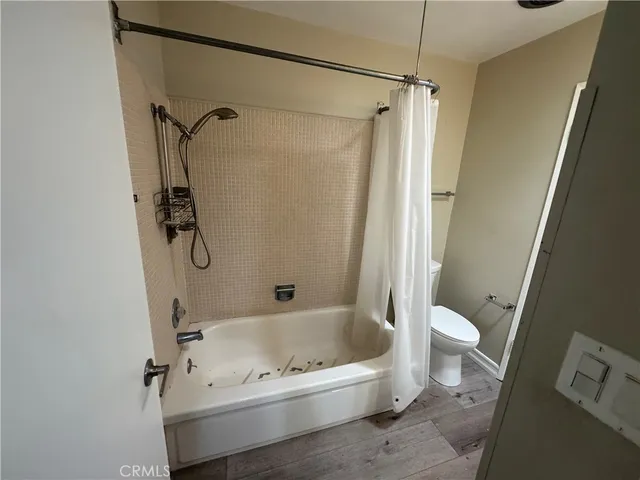 a bathroom with a bathtub a toilet and a shower