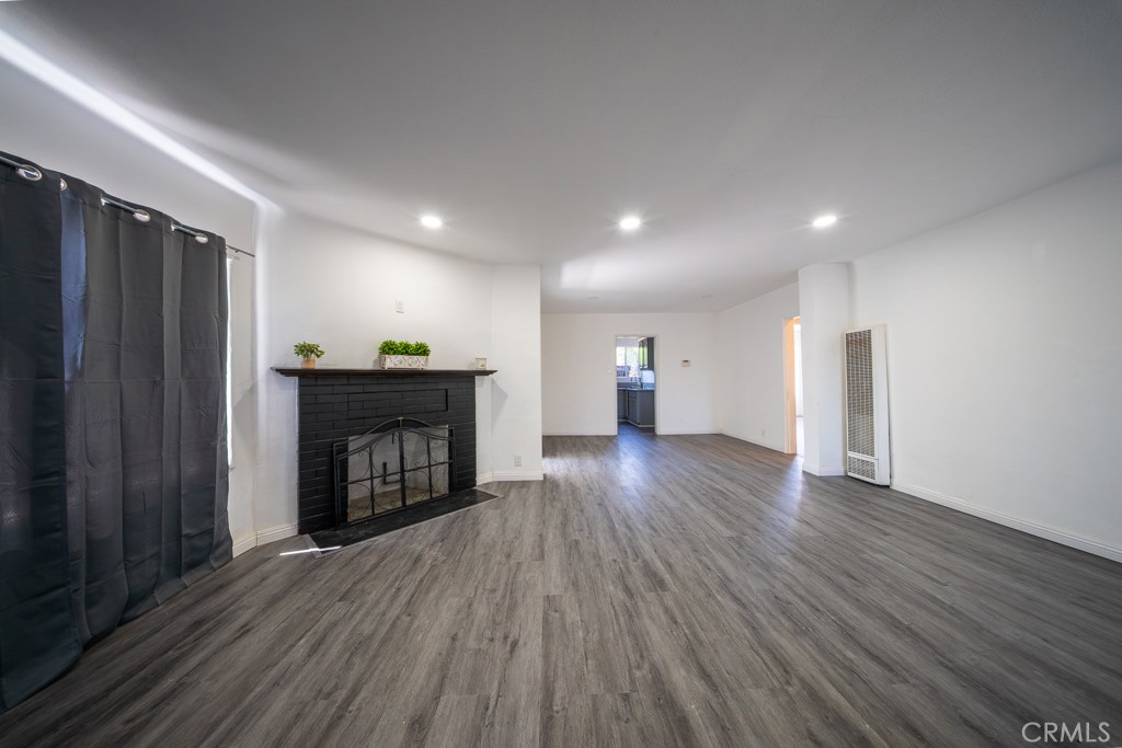 843 West Brazil Street Compton, CA 90220 - Photo 2 of 17 a view of empty room with a fireplace and window