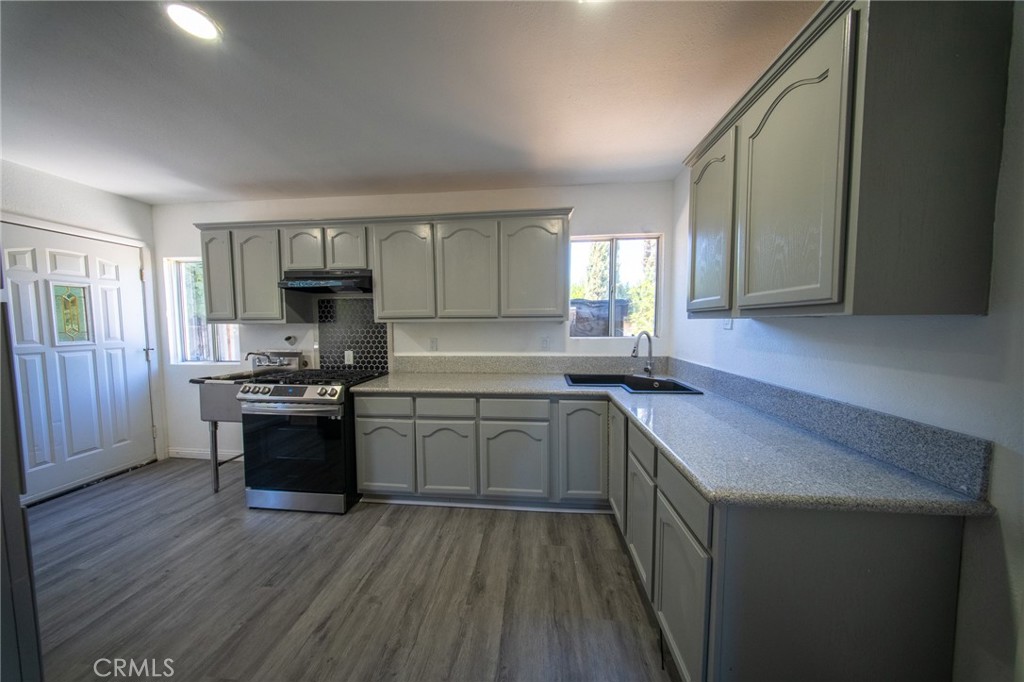 843 West Brazil Street Compton, CA 90220 - Photo 3 of 17 a kitchen with a sink stove top oven and cabinets
