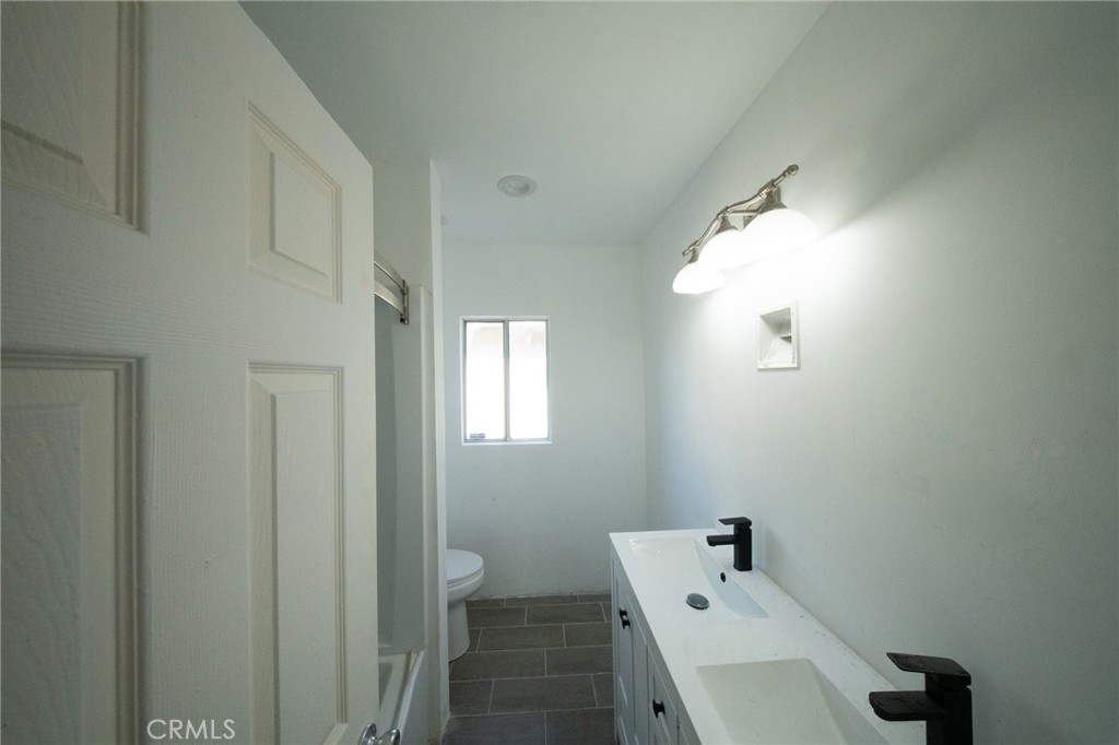 843 West Brazil Street Compton, CA 90220 - Photo 5 of 17 a bathroom with a window