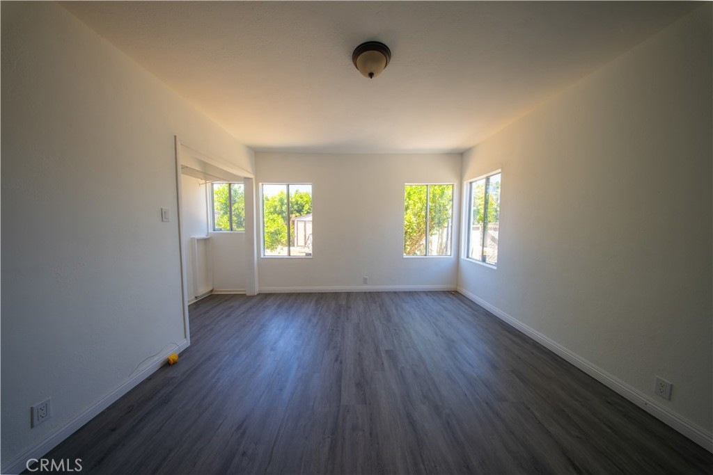 843 West Brazil Street Compton, CA 90220 - Photo 7 of 17 an empty room with wooden floor and windows
