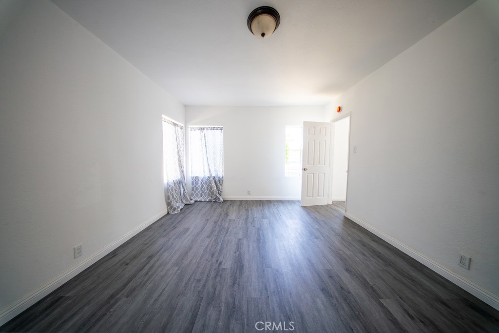 843 West Brazil Street Compton, CA 90220 - Photo 10 of 17 an empty room with wooden floor and windows
