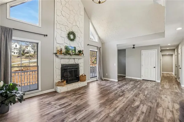 a view of a livingroom with a fireplace and window