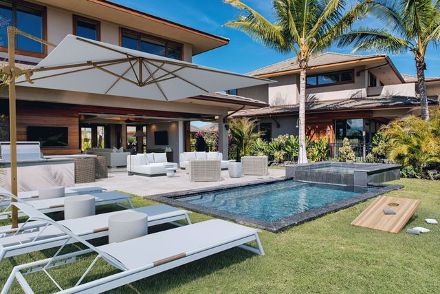 a view of a house with swimming pool and sitting area