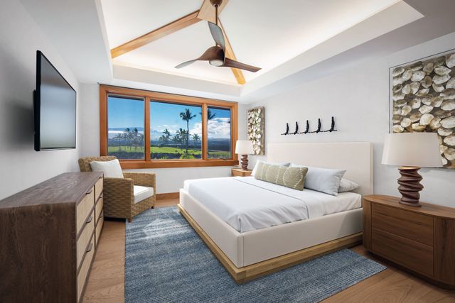 a bedroom with a bed couch and a flat tv screen