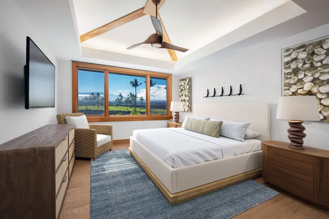 a bedroom with a bed couch and a flat tv screen