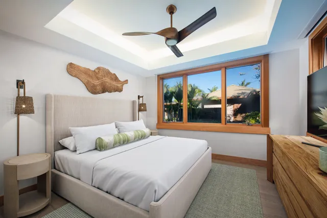 a bedroom with a large bed and a large window