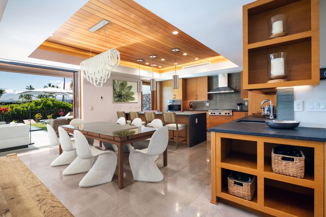 a dining room with furniture and a floor to ceiling window