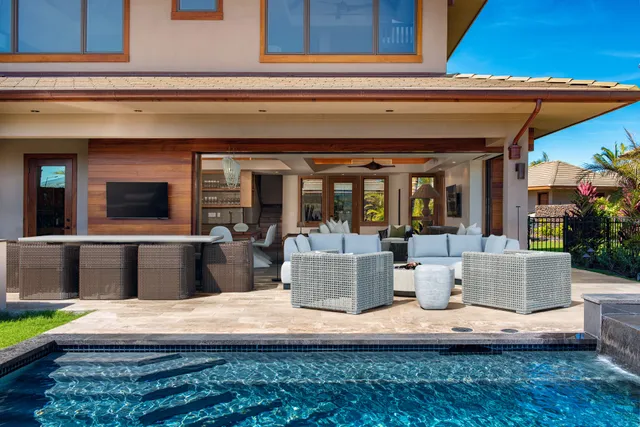 a view of a house with a barbeque grill and couches