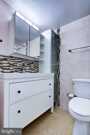 a bathroom with a sink a toilet and a shower