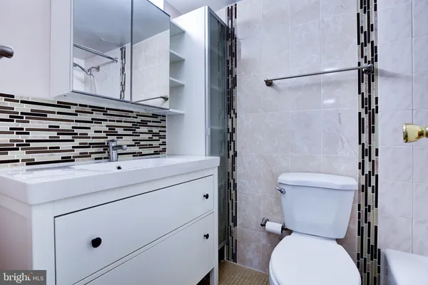 a bathroom with a toilet sink and shower