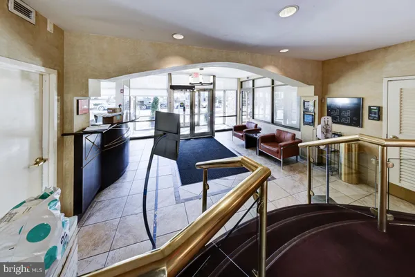 a living room with stainless steel appliances kitchen island granite countertop furniture and a view of kitchen