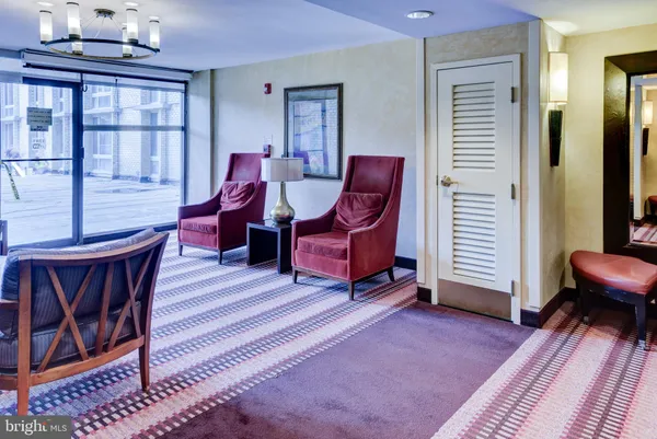 a living room with furniture a window and a rug