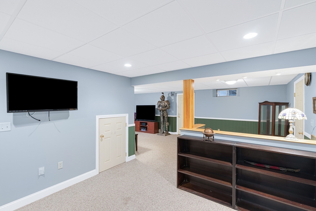 54 Old Merrill Street Amesbury, MA 01913 - Photo 30 of 34 a room with furniture and a flat screen tv