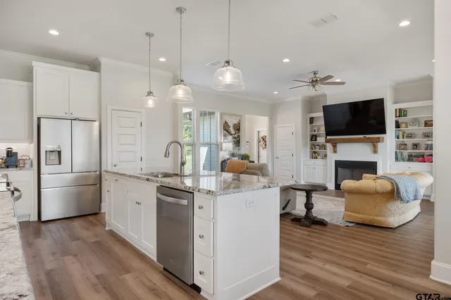 a kitchen with furniture a large window and a fireplace
