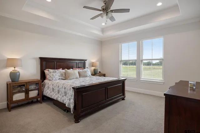 a spacious bedroom with a bed and window