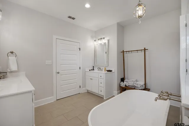 a bathroom with a sink a toilet and mirror