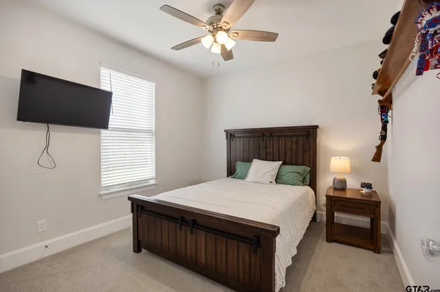 a bedroom with a bed and a flat screen tv