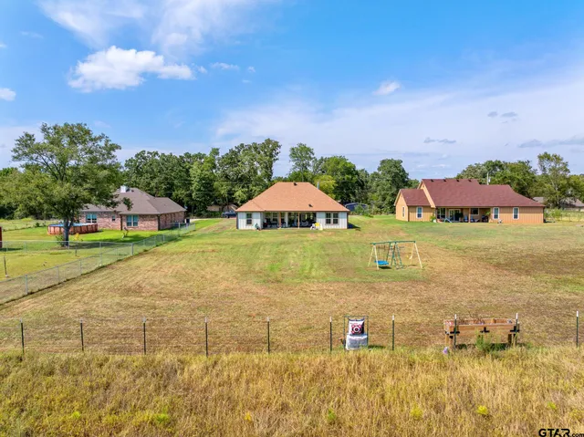 a blue swimming pool is middle in the middle of a yard