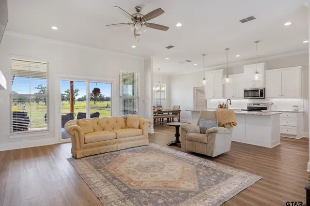 a living room with furniture and a large window
