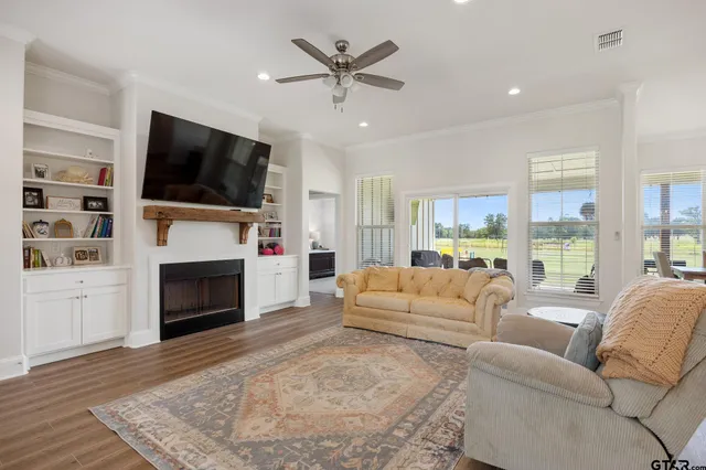 a living room with furniture a flat screen tv and a fireplace
