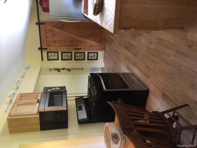 1095 State Rt 17B Mongaup Valley, NY 12762 - Photo 41 of 47 Kitchen with light brown cabinets, wood finished floors, stove, and fridge