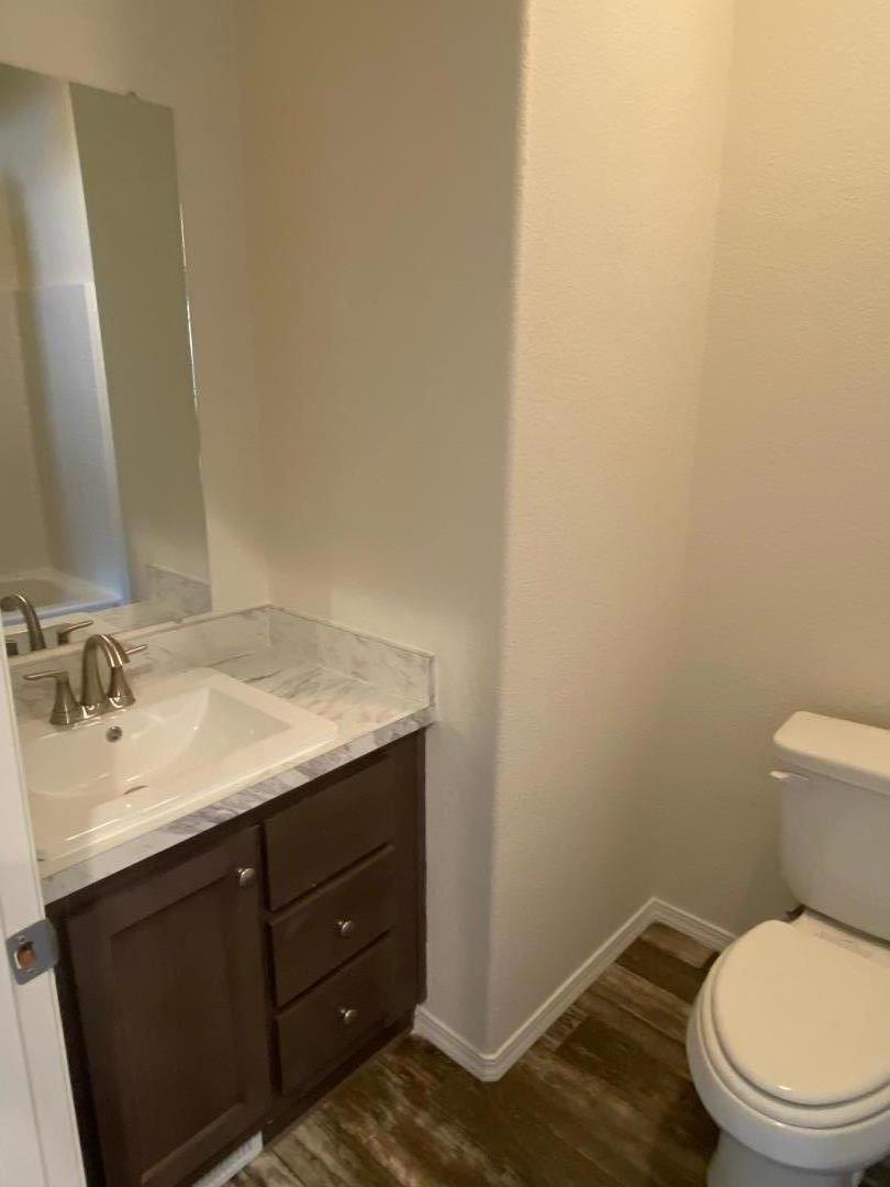 6165 Pony Express Trail, Unit 32 Pollock Pines, CA 95726 - Photo 3 of 7 a bathroom with a granite countertop sink and a toilet