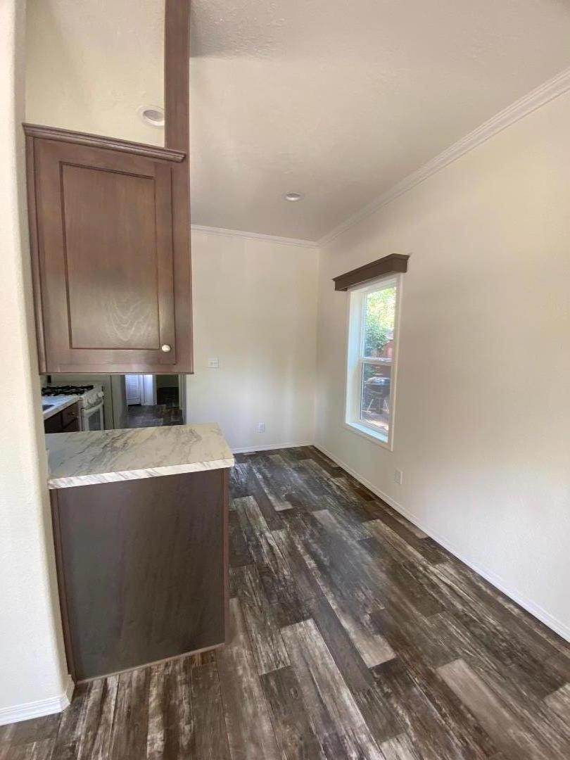 6165 Pony Express Trail, Unit 32 Pollock Pines, CA 95726 - Photo 7 of 7 a view of a bedroom with a bed and wooden floor