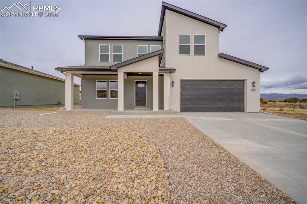 205 High Meadows Drive Florence, CO 81226 - Photo 1 of 28 a front view of a house with a yard and garage