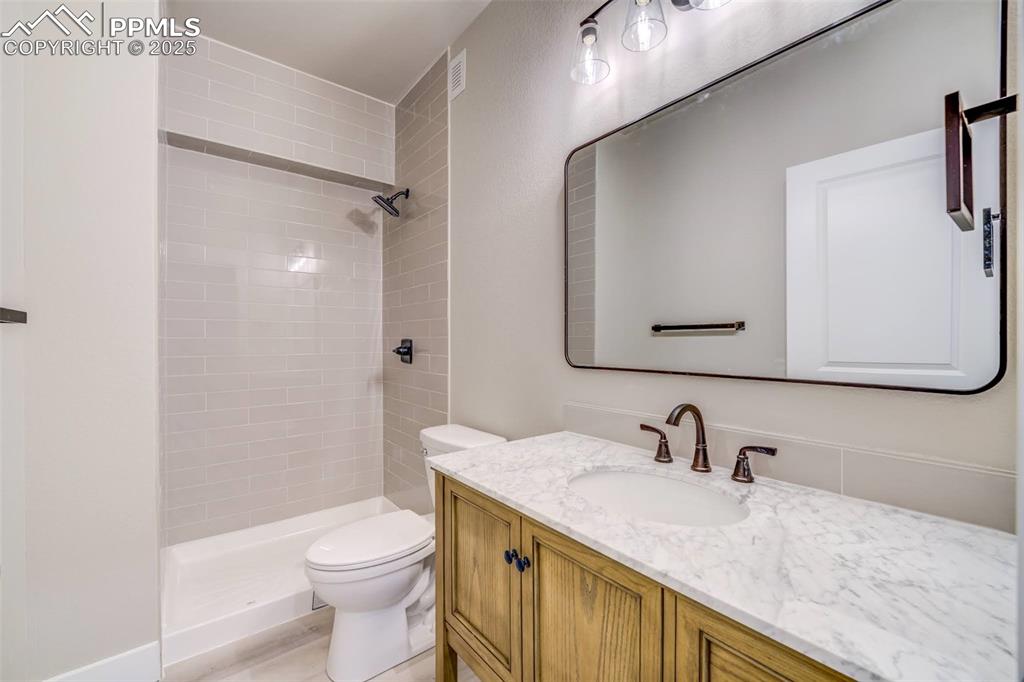 205 High Meadows Drive Florence, CO 81226 - Photo 18 of 28 a bathroom with a granite countertop sink toilet and shower
