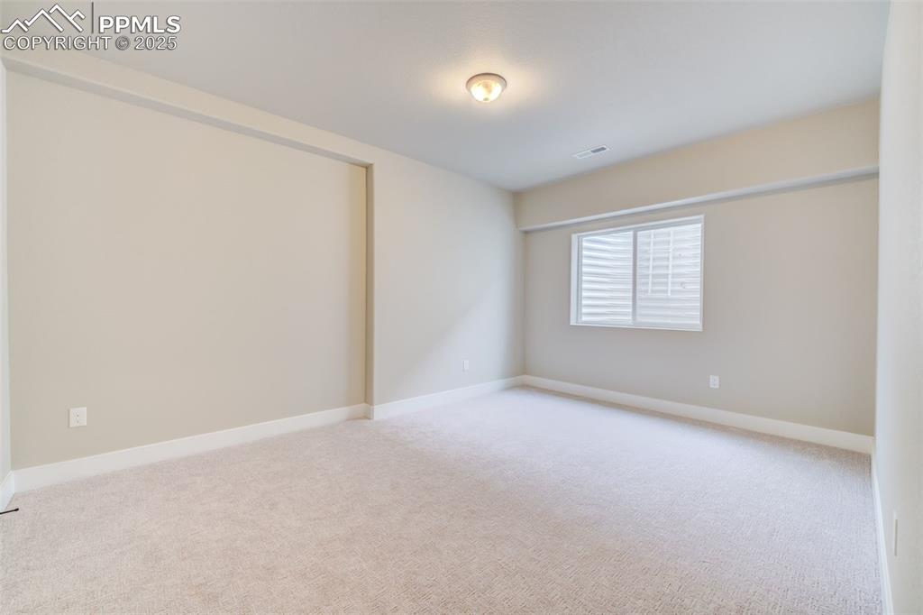 205 High Meadows Drive Florence, CO 81226 - Photo 22 of 28 an empty room with windows
