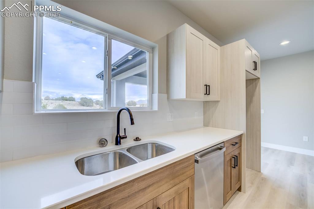205 High Meadows Drive Florence, CO 81226 - Photo 4 of 28 a kitchen with stainless steel appliances granite countertop a sink a stove and a refrigerator with wooden floor