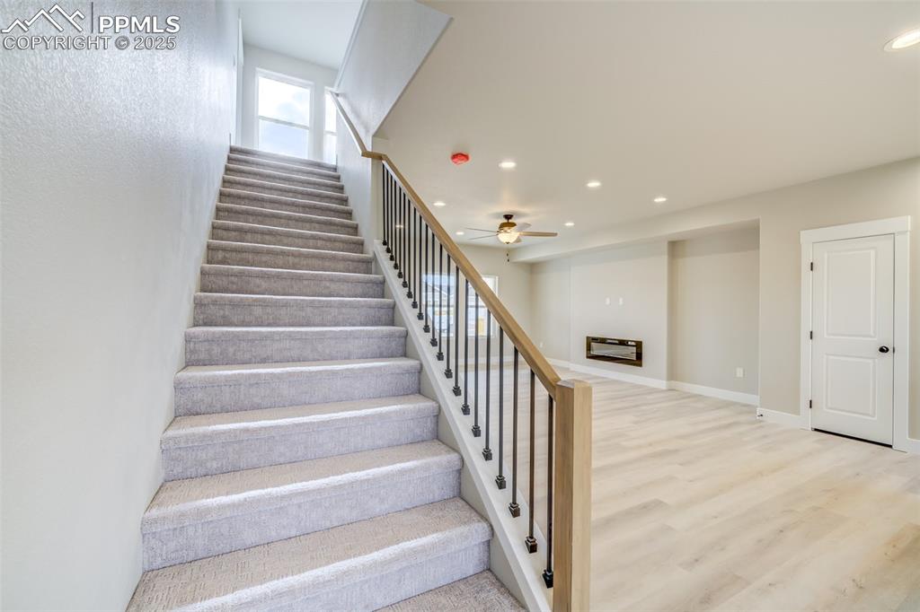 205 High Meadows Drive Florence, CO 81226 - Photo 5 of 28 a view of staircase with lots of frames on wall and a window