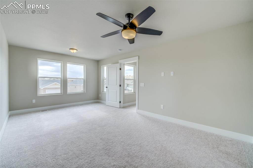 205 High Meadows Drive Florence, CO 81226 - Photo 6 of 28 an empty room with closet and windows