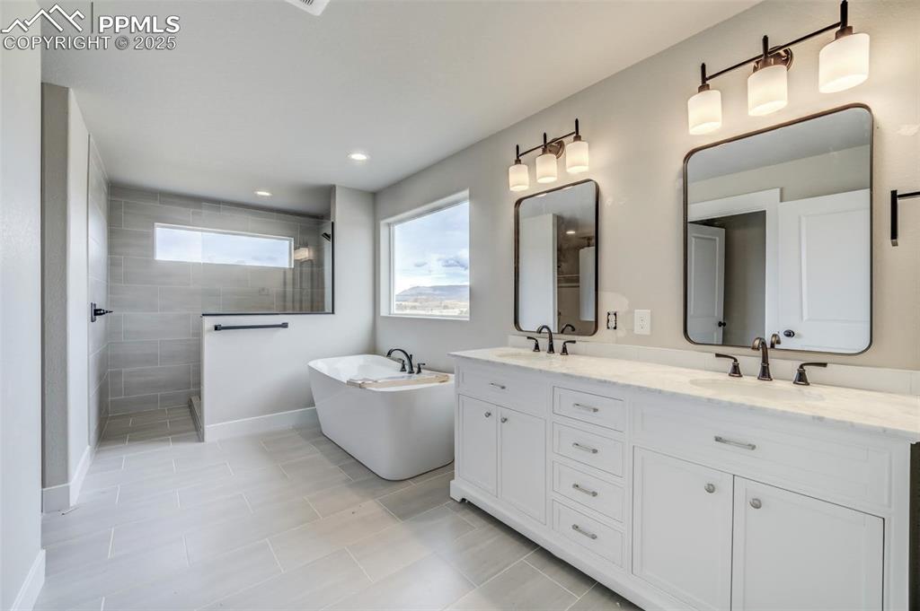205 High Meadows Drive Florence, CO 81226 - Photo 8 of 28 a spacious bathroom with a double vanity sink mirror and a bathtub
