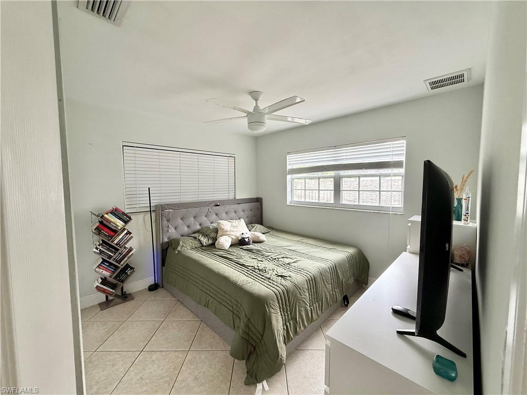 1964 42nd Street Southwest Naples, FL 34116 - Photo 15 of 25 a bedroom with a bed and a window