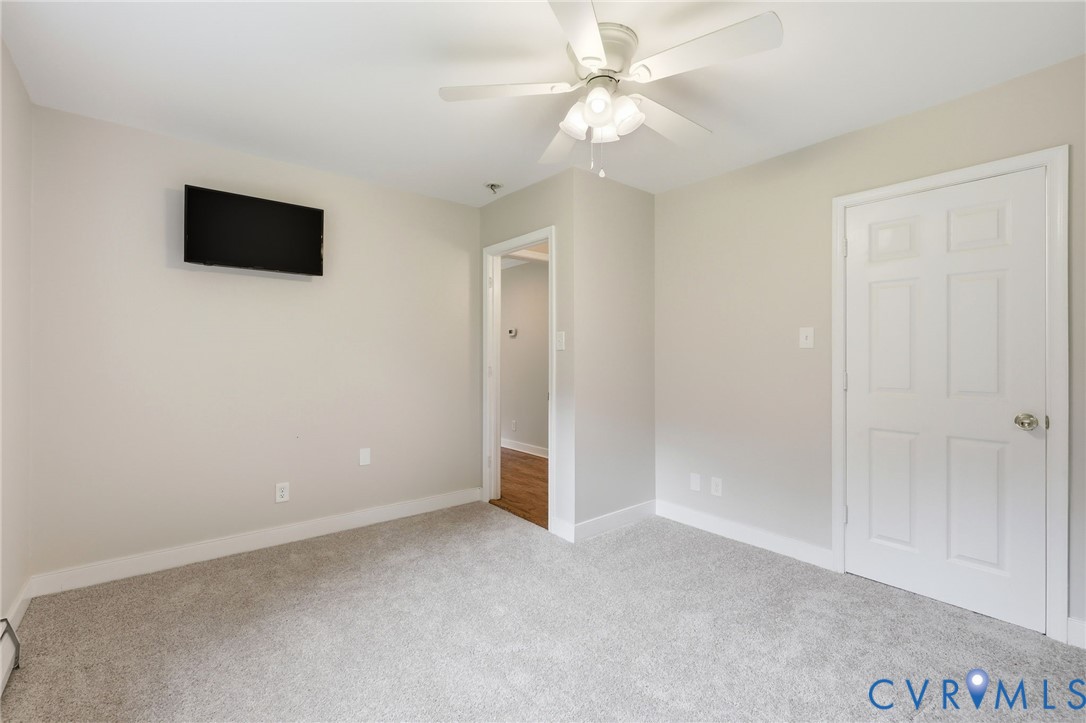 10152 Georgetown Road Mechanicsville, VA 23116 - Photo 18 of 35 wooden floor in an empty room with a ceiling fan