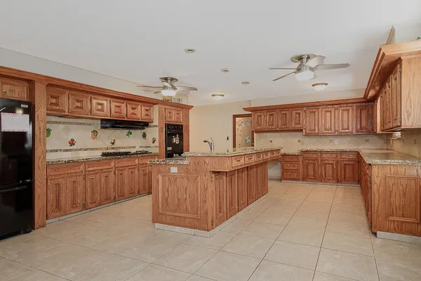 a kitchen with stainless steel appliances a sink counter top space and cabinets