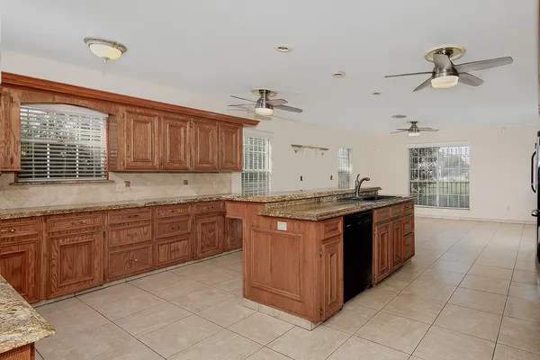 a kitchen with granite countertop a sink and a stove