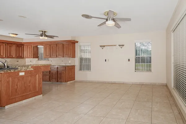 a view of kitchen with granite countertop cabinets and window