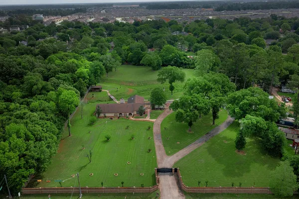 an aerial view of a residential houses with outdoor space and garden