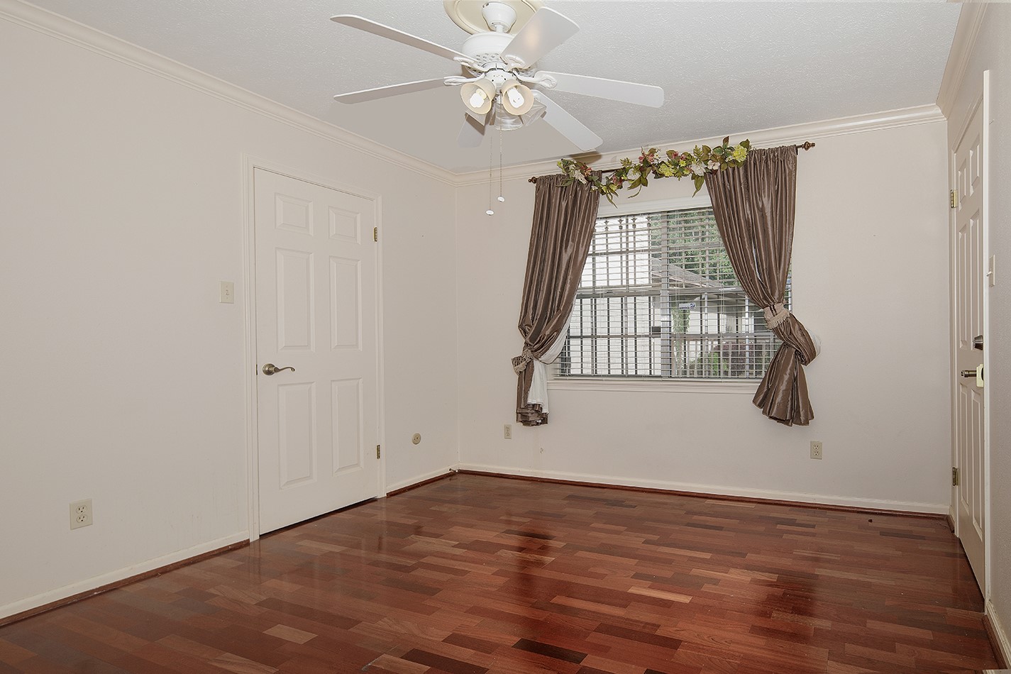 23218 Aldine Westfield Road Spring, TX 77373 - Photo 25 of 47 an empty room with wooden floor fan and windows