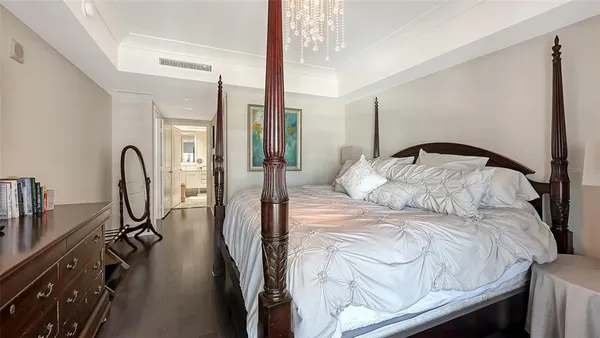a bedroom with a bed next to a large mirror